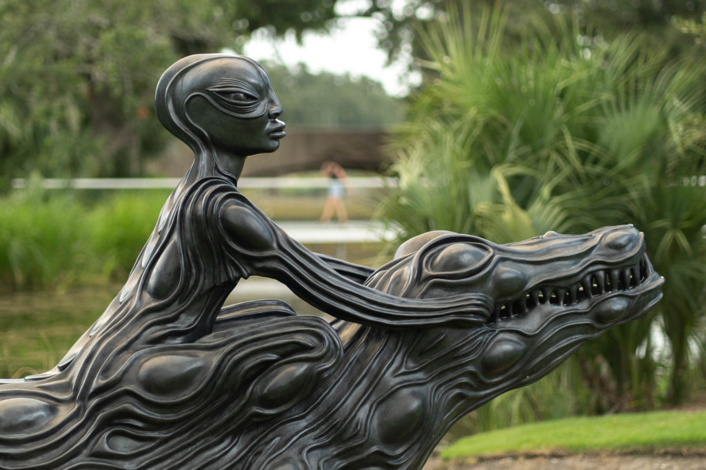sculpture of woman on alligator